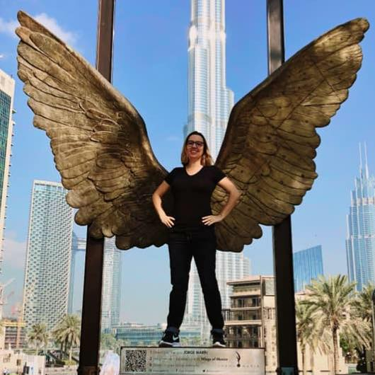Influencer Courtney Brandt with wing statue