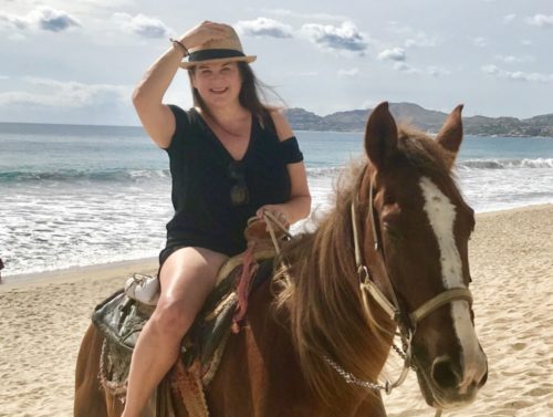 Travel Influencer Dr. Cacinda Maloney Horseback on Beach