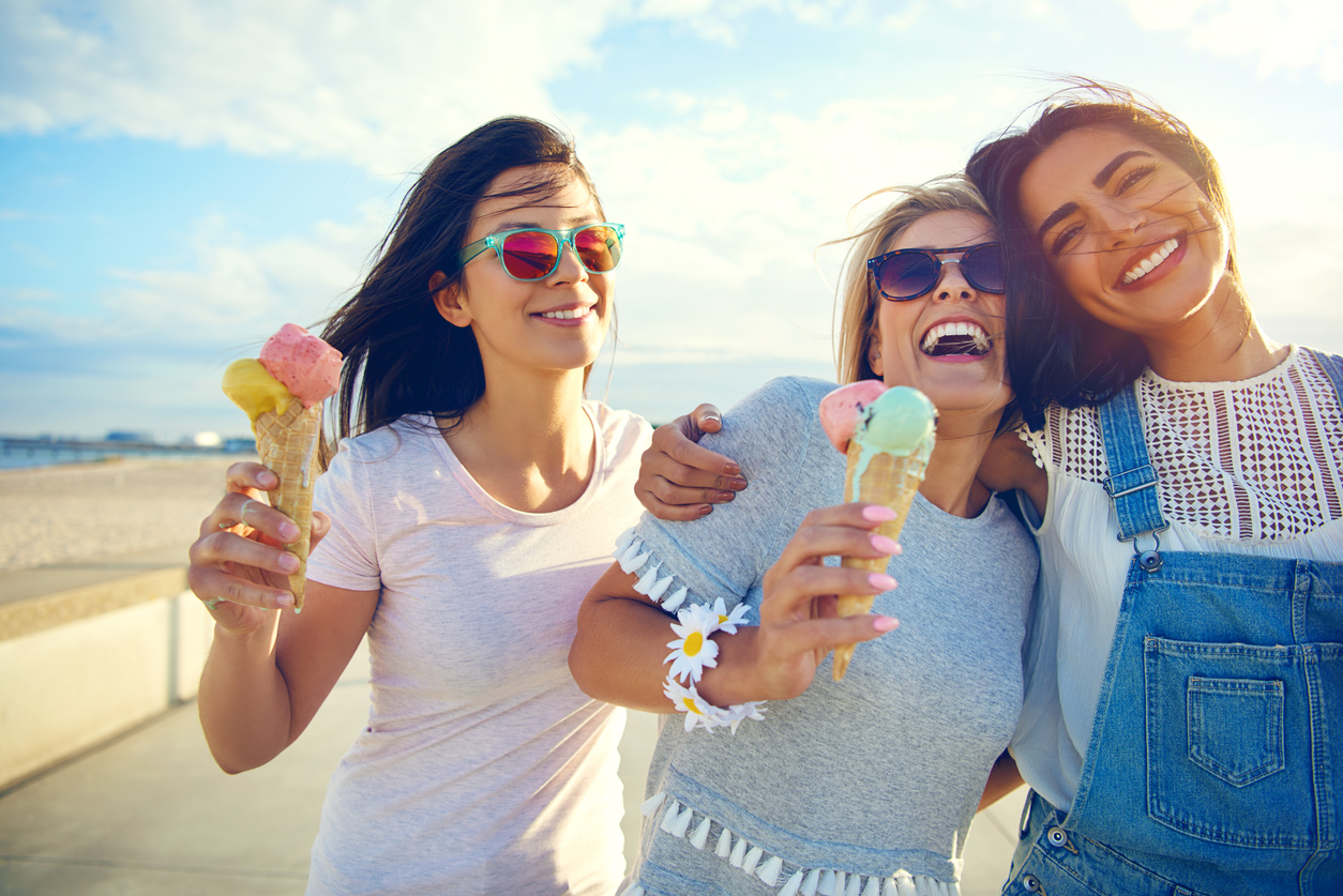 women friends eating ice cream and laughing