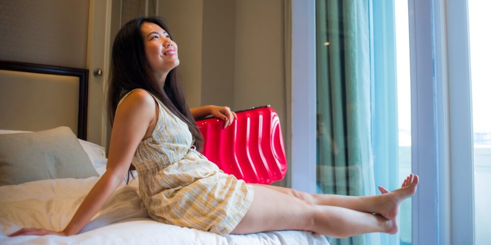travel instagram influencer in hotel room with luggage